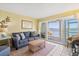 Comfortable living area features plush seating and sliding doors to an outdoor patio at 46 Mariners Cay Dr, Folly Beach, SC 29439