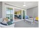 Spacious screened-in porch with a comfortable seating area and a glimpse of the living room at 46 Mariners Cay Dr, Folly Beach, SC 29439