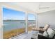 Inviting sunroom with comfortable seating and panoramic views of the waterfront at 46 Mariners Cay Dr, Folly Beach, SC 29439