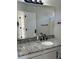 Bright bathroom with large mirror, granite countertop, and modern black fixtures at 5082 Westview St, North Charleston, SC 29418