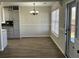 Bright dining room area with wood-look flooring, chandelier and view into the kitchen with gray cabinets at 5082 Westview St, North Charleston, SC 29418