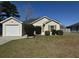 Charming single-story home with tan siding, green shutters, manicured landscaping and a one-car garage at 5082 Westview St, North Charleston, SC 29418
