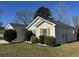 Side exterior view of the property showing the siding, landscaping and the green shutters at 5082 Westview St, North Charleston, SC 29418