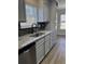 Modern kitchen features stainless steel dishwasher, granite counters, and updated cabinets at 5082 Westview St, North Charleston, SC 29418