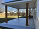 Covered outdoor patio with tile flooring and wood support columns at 5082 Westview St, North Charleston, SC 29418