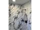 Beautiful shower with black fixtures and white marble-patterned tile at 5082 Westview St, North Charleston, SC 29418