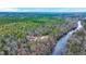 Waterfront home with a private road amid dense, lush green forest and open skies at 5585 Wire Road, Branchville, SC 29432