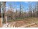 Wood steps lead down to a scenic backyard with a view of a serene river and surrounding forest at 5585 Wire Road, Branchville, SC 29432