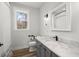 Charming bathroom with a marble countertop vanity and gray cabinets below a framed mirror at 5585 Wire Road, Branchville, SC 29432