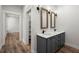 Bathroom features a double vanity, decorative lighting, wood-look floors, and a walk-in closet at 5585 Wire Road, Branchville, SC 29432