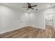 Bedroom featuring wood-look floors, a ceiling fan, and access to the en-suite bathroom at 5585 Wire Road, Branchville, SC 29432
