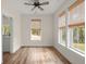 Bedroom featuring hardwood floors, windows with bamboo shades, a ceiling fan, and natural light at 5585 Wire Road, Branchville, SC 29432