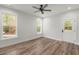 Bedroom featuring wood-look floors, a ceiling fan, a door to the outside, and natural light at 5585 Wire Road, Branchville, SC 29432