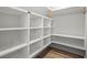 Walk-in closet with shelving, white walls, and wood-look flooring at 5585 Wire Road, Branchville, SC 29432