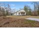 View of white home showing covered porch and screened patio with a concrete pad on the lawn at 5585 Wire Road, Branchville, SC 29432