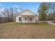Charming white house with a covered front porch, set on a spacious grassy lot with mature trees at 5585 Wire Road, Branchville, SC 29432