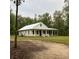 Charming single-story home features a metal roof, screened porch, and well-maintained lawn at 5585 Wire Road, Branchville, SC 29432