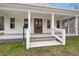 Covered front porch with wood columns, double wood front doors, and an adjacent screened porch at 5585 Wire Road, Branchville, SC 29432