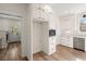 White kitchen with stainless steel dishwasher, oven, lots of cabinet space, and wood-look flooring at 5585 Wire Road, Branchville, SC 29432