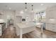 Modern kitchen with a large island, pendant lighting, and stainless steel appliances at 5585 Wire Road, Branchville, SC 29432
