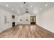 Open living room with wood floors, fireplace, and double doors at 5585 Wire Road, Branchville, SC 29432