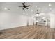 Hardwood floors featured in a spacious living room adjacent to a contemporary, white kitchen at 5585 Wire Road, Branchville, SC 29432