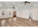 Spacious living room with wood floors, ceiling fans, recessed lighting, and double doors at 5585 Wire Road, Branchville, SC 29432