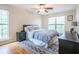Bright bedroom with large windows, ceiling fan, and wood-look floors at 700 Daniel Ellis Dr # 13302, Charleston, SC 29412