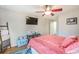 Cozy bedroom featuring a ceiling fan, desk, mounted TV, and a stylish blue area rug at 700 Daniel Ellis Dr # 13302, Charleston, SC 29412