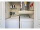 Functional laundry room featuring a side-by-side washer and dryer with shelf and storage at 700 Daniel Ellis Dr # 13302, Charleston, SC 29412