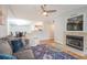 Open-concept living room with fireplace, ceiling fan, and view to dining area and kitchen at 700 Daniel Ellis Dr # 13302, Charleston, SC 29412