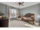 Bright Bedroom featuring a wooden crib, comfy chair, and natural light from the window at 7271 Sweetgrass Blvd, Hanahan, SC 29410