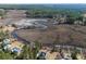 Expansive aerial view capturing the community nestled along a river and marsh, complete with private docks at 7527 Ladys Secret Ln, Awendaw, SC 29429