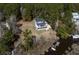 Aerial view of the home showing the proximity to the water and private dock, surrounded by lush forestry at 7527 Ladys Secret Ln, Awendaw, SC 29429