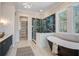 Elegant bathroom showcasing a luxurious soaking tub, a glass-enclosed shower, and a walk-in closet at 7527 Ladys Secret Ln, Awendaw, SC 29429