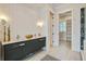 Stylish bathroom features a double vanity with modern fixtures and a doorway to a walk-in closet at 7527 Ladys Secret Ln, Awendaw, SC 29429