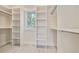 Well-organized walk-in closet with custom shelving and ample storage space with bright window at 7527 Ladys Secret Ln, Awendaw, SC 29429