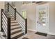 Staircase with a view of the entry door, creating a warm and inviting entrance to the home at 7527 Ladys Secret Ln, Awendaw, SC 29429