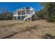 Back of the home with spacious grassy lot at 7527 Ladys Secret Ln, Awendaw, SC 29429