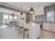 Modern kitchen and dining area bathed in natural light, complete with island seating at 7527 Ladys Secret Ln, Awendaw, SC 29429