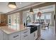 Modern kitchen island with sleek countertop, black faucet, and open layout to dining at 7527 Ladys Secret Ln, Awendaw, SC 29429