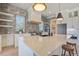 Gourmet kitchen with stainless steel appliances, island with bar seating, and custom backsplash at 7527 Ladys Secret Ln, Awendaw, SC 29429