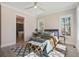 A serene bedroom featuring natural light, ceiling fan, and an ensuite bathroom for added convenience at 7527 Ladys Secret Ln, Awendaw, SC 29429