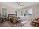 Light-filled bedroom with large windows offering picturesque views of the outdoor landscape and ceiling fan at 7527 Ladys Secret Ln, Awendaw, SC 29429