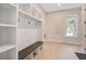Functional mudroom with built-in storage, bench, and hooks, providing a convenient entryway solution at 7527 Ladys Secret Ln, Awendaw, SC 29429