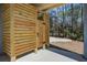 Exterior cedar plank outdoor shower with adjacent gravel parking area at 7527 Ladys Secret Ln, Awendaw, SC 29429