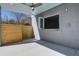 Covered outdoor patio featuring ceiling fan, pass through window, and privacy fence at 7527 Ladys Secret Ln, Awendaw, SC 29429