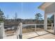 Back porch with wooden floors and white railings offering lovely lake views at 7527 Ladys Secret Ln, Awendaw, SC 29429