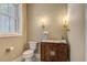 Charming powder room with a stylish vanity, modern lighting, and elegant fixtures at 7527 Ladys Secret Ln, Awendaw, SC 29429