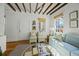 Bright living room features exposed wood beam ceilings and comfortable seating at 78 Nassau St, Charleston, SC 29403